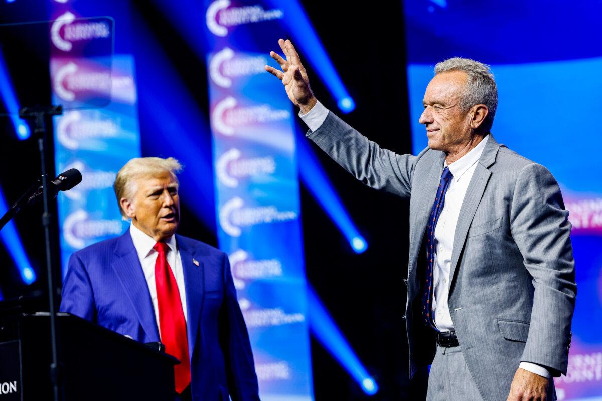 The then-Republican presidential nominee and former U.S. President Donald Trump welcomes Robert F. Kennedy Jr. to the stage at a Turning Point Action campaign rally at the Gas South Arena in Duluth, Ga., on Oct. 23, 2024. (Anna Moneymaker/Getty Images)