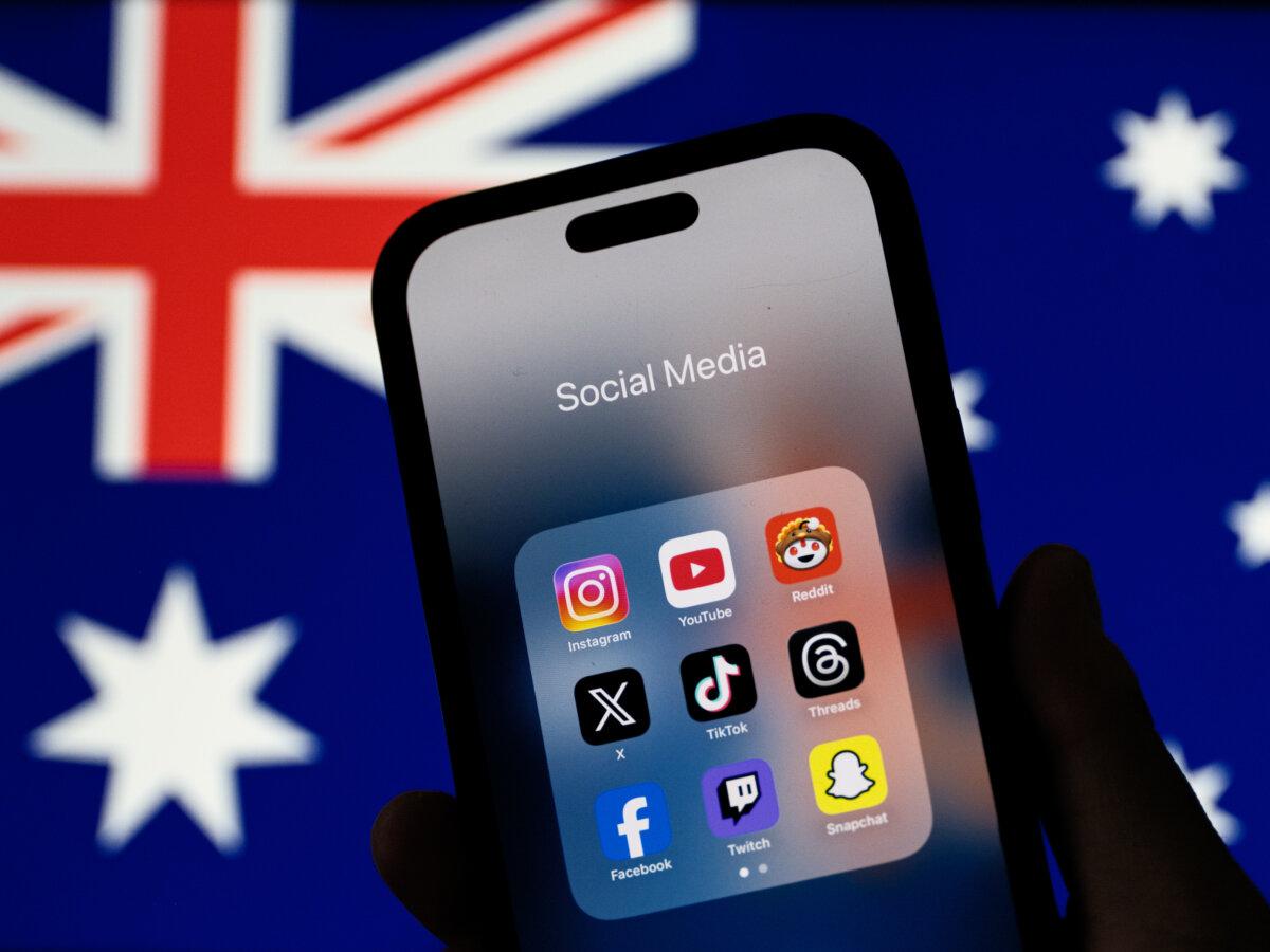 In this photo illustration, social media networking apps are displayed on a phone screen with the Australian flag displayed in the background in Sydney, Australia, on Dec. 7, 2025. (Illustration by George Chan/Getty Images)