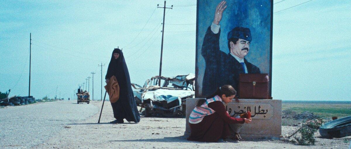 Bibi (Waheed Thabet Khreibat) waits as Lamia (Baneen Ahmad Nayyef) looks after her pet rooster, in ‘The President’s Cake.” (Sony Pictures Classics)