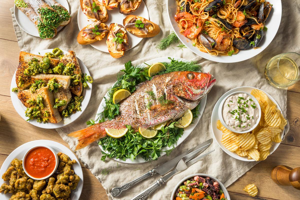 An Italian spread for the Feast of the Seven Fishes includes snapper, octopus, and a pasta dish. (Brent Hofacker/Shutterstock)