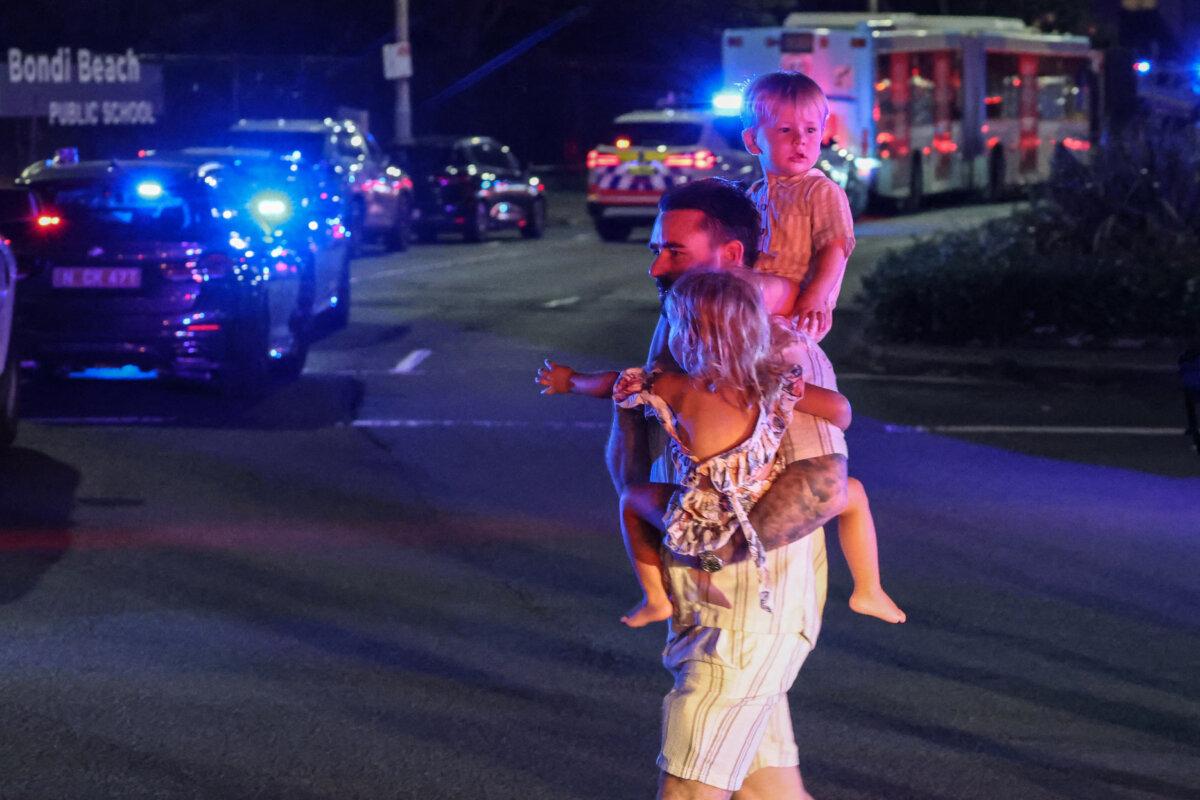 People cross a street after a shooting incident at Bondi Beach in Sydney on Dec. 14, 2025. (David Gray/ AFP via Getty Images)
