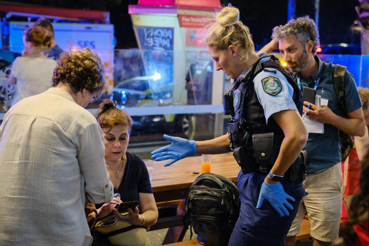 Police first responders speak to members of the public at the scene of a mass shooting at Bondi Beach in Sydney, Australia, on Dec. 14, 2025. (George Chan/Getty Images)