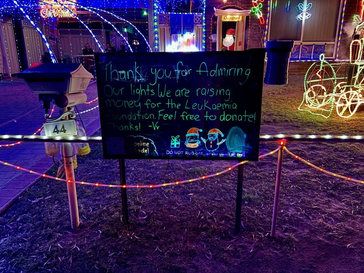 The fundraising sign in front of a home decked out in Christmas decoration in Sydney's Kellyville, Australia. (Epoch Times Sydney staff)