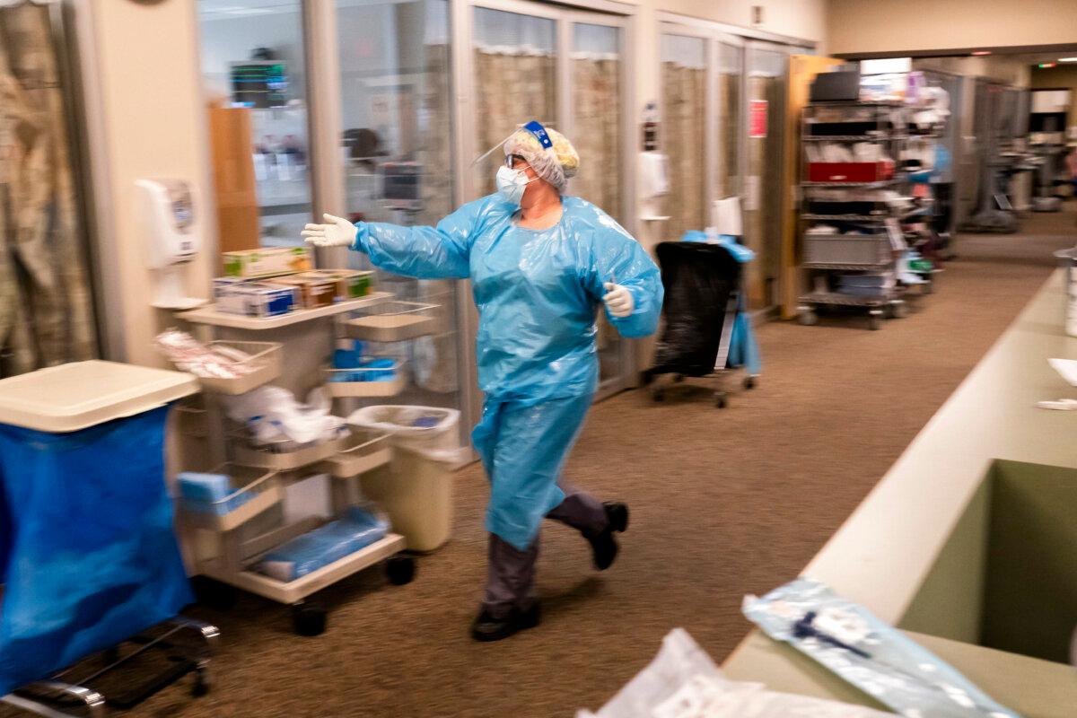 A nurse at Three Rivers Asante Medical Center runs to a room in the Intensive Care Unit to help as medical staff treat a COVID-19 patient in Grants Pass, Ore., on Sept. 9, 2021. (Nathan Howard/Getty Images)