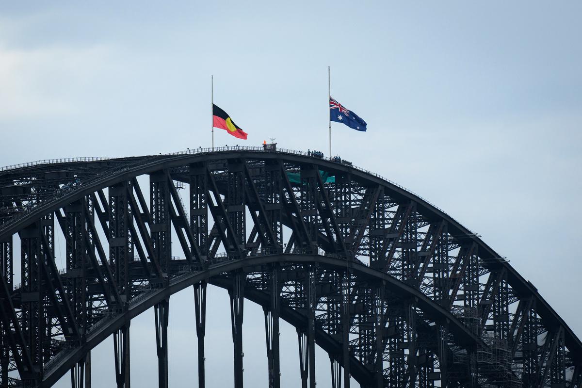 The Australian and Aboriginal flags fly at half mast on Sydney Harbour Bridge in Sydney, Australia, on Dec. 21, 2025. (George Chan/AFP via Getty Images)