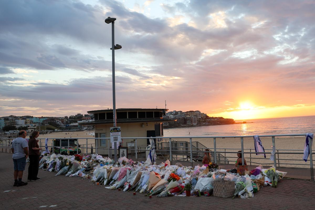 Mourners looking at the flower memorial laid next to Bondi Beach on Dec. 21, 2025. (Izhar Khan/Getty Images)