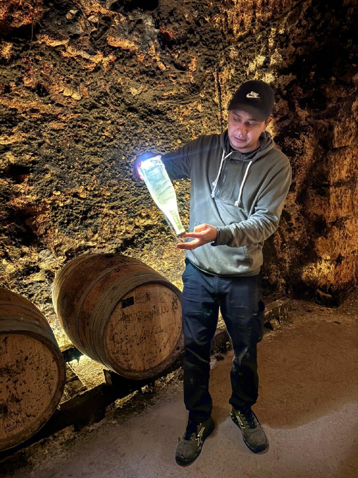 A tour of the limestone cellars at Bodegas Jesus Diaz e Hijos—excavated by Franciscan monks in the 16th century—includes a demonstration showing sediment during the wine fermentation process. (Photo courtesy of Alison Ramsey)