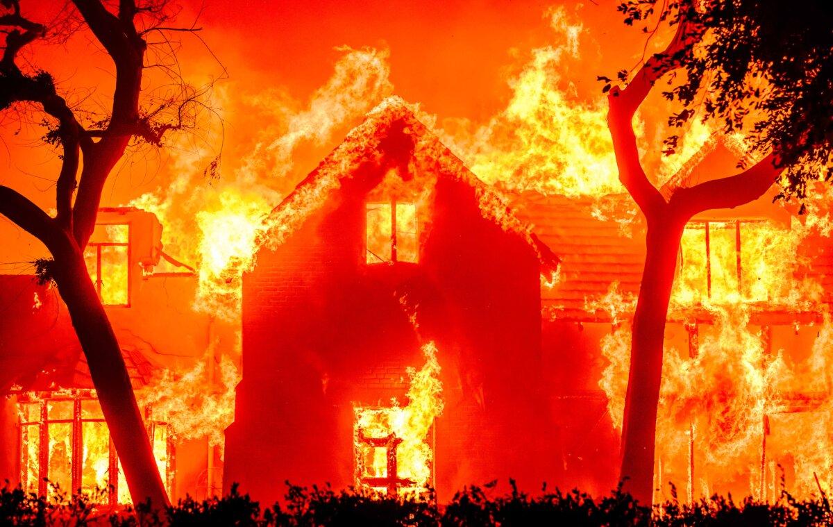 A home is engulfed in flames during the Eaton fire in the Altadena area of Los Angeles County, Calif., on Jan. 8, 2025. (Josh Edelson/AFP via Getty Images)