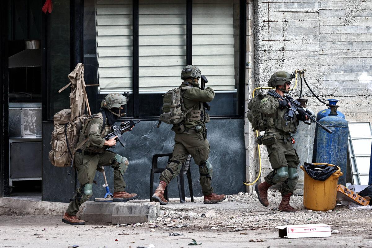 Israeli soldiers deploy in a street during a military raid in the Palestinian village of Qabatiya in the West Bank, on Dec. 27, 2025. (Zain Jaafar/AFP)