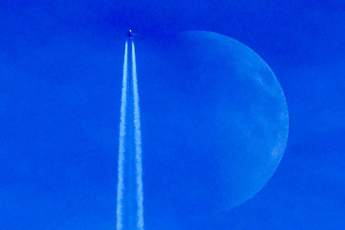 A Boeing 737 Max 8-200 aircraft of Irish budget airline Ryanair flies past the Waxing crescent moon in Frankfurt am Main, Germany, on Dec. 27, 2025. (Kirill Kudryavtsev/AFP via Getty Images)