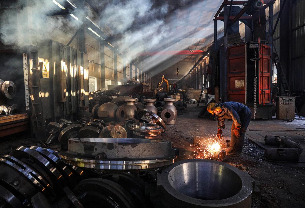 A worker is shown on the floor of a steel machinery factory in Hangzhou, Zhejiang Province, China, on June 6, 2025. (STR/AFP via Getty Images)