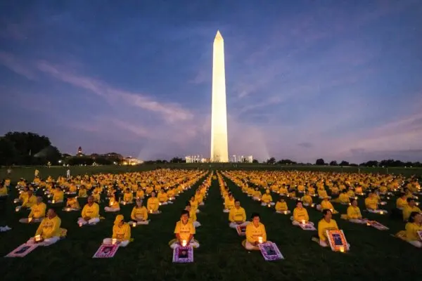 Over a thousand Falun Gong practitioners hold a candlelight vigil commemorating Falun Gong practitioners who were persecuted to death by the Chinese Communist Party in China, at the Washington Monument in Washington, D.C., on July 21, 2022. (Samira Bouaou/The Epoch Times)