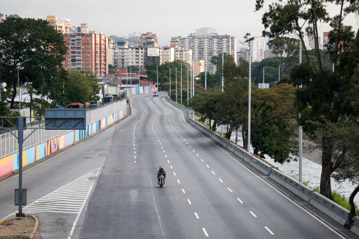 A motorcycle rides along an empty street in Caracas on Jan. 3, 2026, after US forces captured Venezuelan leader Nicolás Maduro. (Pedro Mattey/AFP via Getty Images)