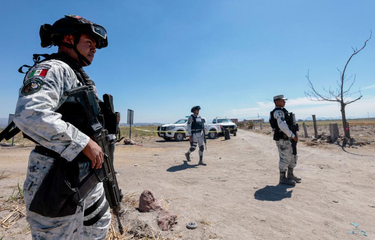 Members of the National Guard patrol the Izaguirre Ranch in Tehuchitlan, Jalisco State, Mexico, on March 19, 2025, where the “Guerreros Buscadores” collective located three human crematoriums while searching for their relatives on March 5. (Ulises Ruiz/AFP via Getty Images)