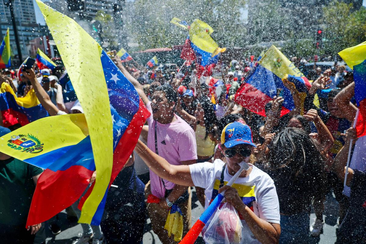 Venezuelan migrants celebrate after U.S. forces captured Venezuelan leader Nicolás Maduro, in Santiago, Chile, on Jan. 3, 2026. (Javier Torres/AFP via Getty Images)