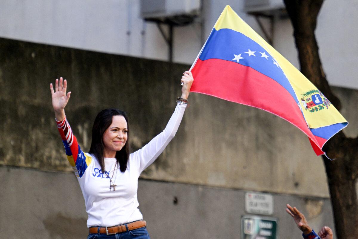 Venezuelan opposition leader Maria Corina Machado waves a national flag during a protest called by the opposition on the eve of the presidential inauguration, in Caracas, Venezuela, on Jan. 9, 2025. (JUAN BARRETO/AFP via Getty Images)