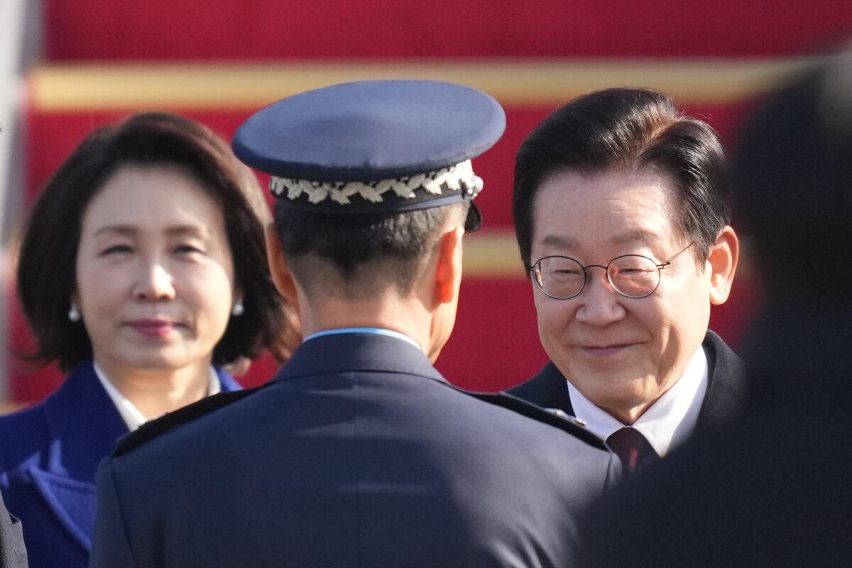 South Korean President Lee Jae Myung and his wife Kim Hea Kyung are greeted before leaving for China at the Seoul airport in Seongnam, South Korea, on Jan. 4, 2026. (Lee Jin-man/AP Photo)