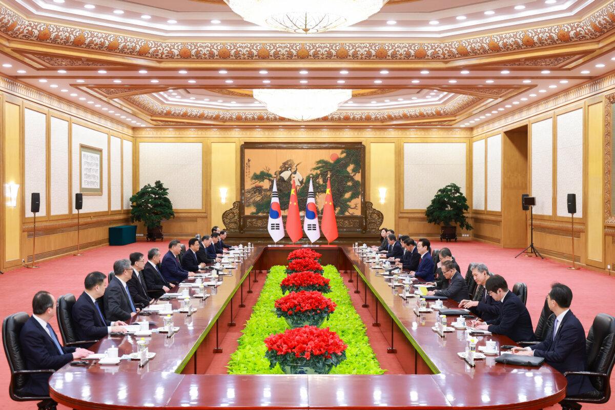In this photo released by Xinhua News Agency, Chinese leader Xi Jinping (6th L) talks to South Korean President Lee Jae-myung (6th R) during the bilateral meeting in Beijing on Jan. 5, 2026. (Liu Bin/Xinhua via AP)