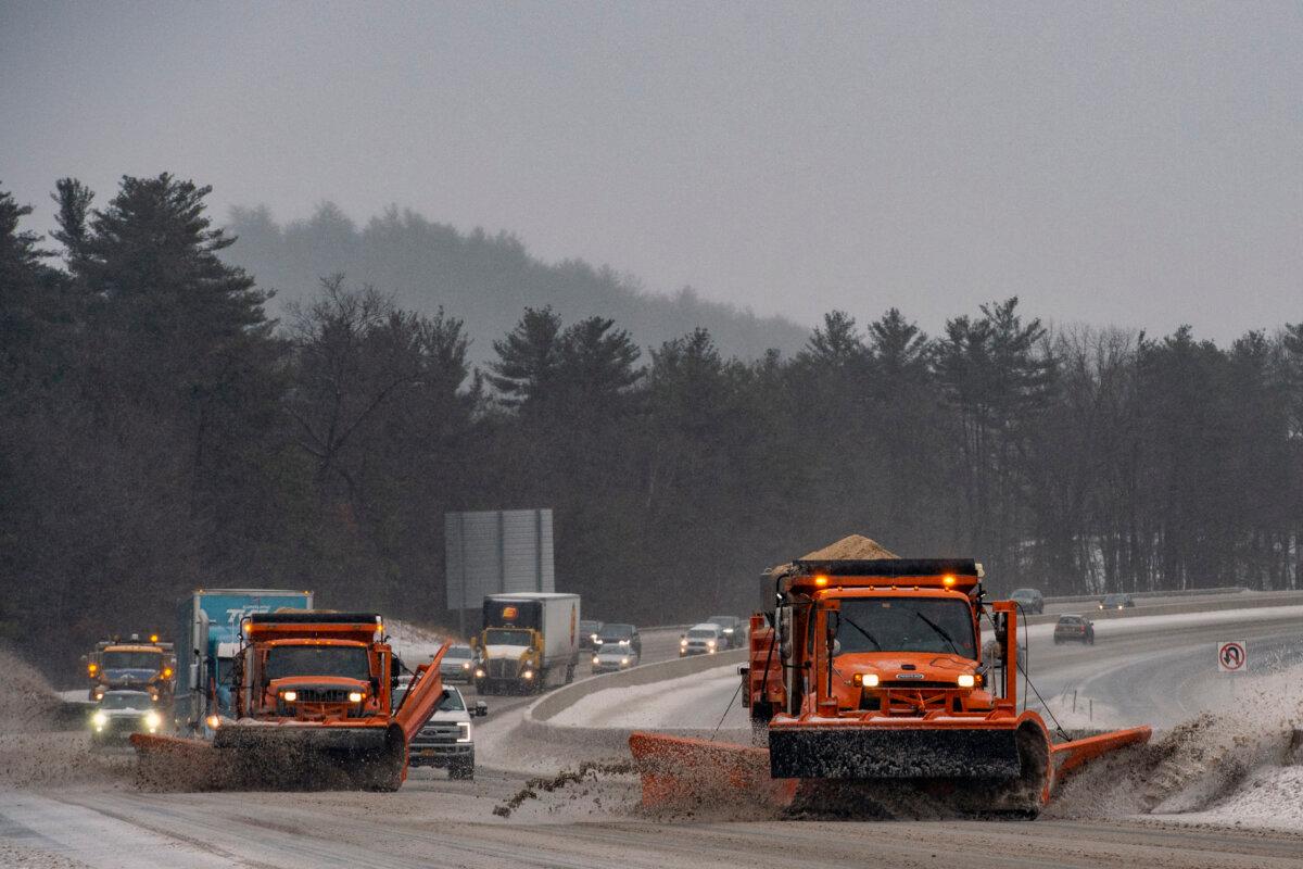 Snow Plows trucks clear snow and ice from Interstate highway 93 during a winter storm in Hooksett, N.H., on Feb. 4, 2022. (Joseph Prezioso/AFP via Getty Images)