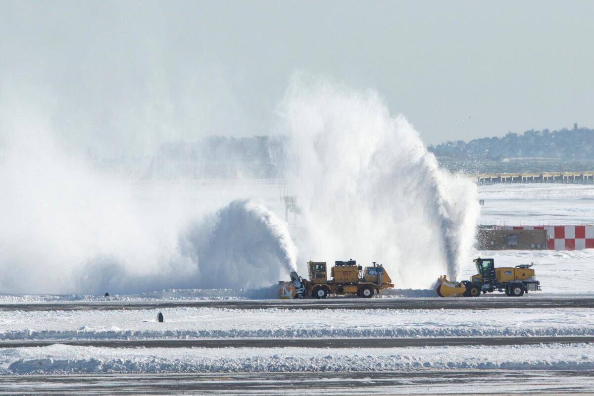 Snow removal equipment operators work the taxiway and runways at Logan International Airport following a “bomb cyclone” the previous day in Boston, Mass., on Jan. 5, 2018. (Scott Eisen/Getty Images)