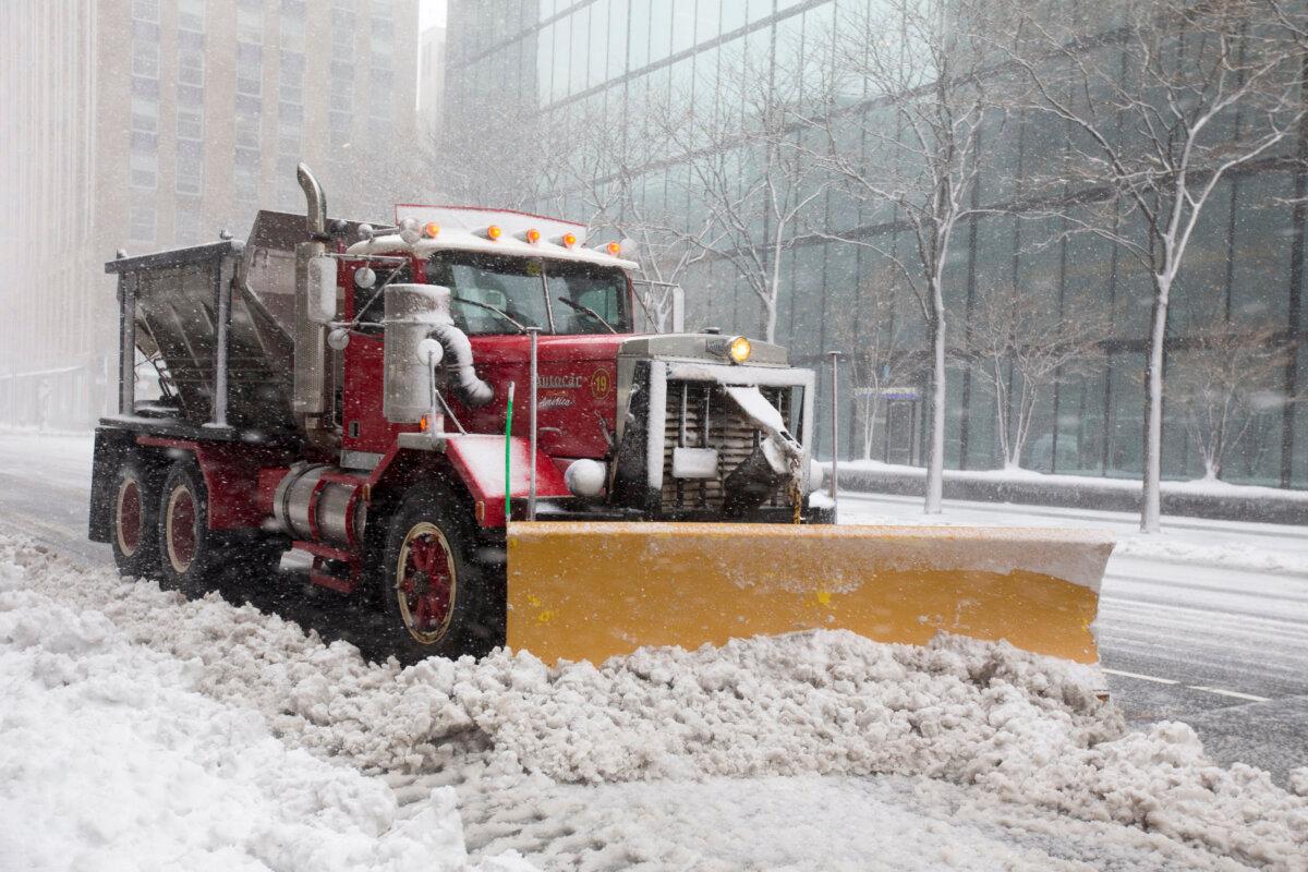 A snow plow clears a road in Boston, Mass., on March 13, 2018. (Scott Eisen/Getty Images)