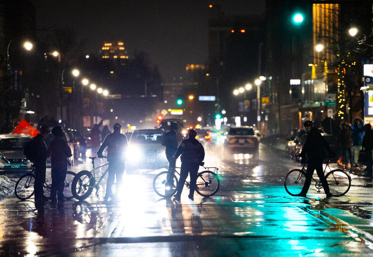 Protesters demonstrating against Immigration and Customs Enforcement (ICE) operations block traffic with bicycles in Minneapolis on Jan. 8, 2026. (John Fredricks/The Epoch Times)