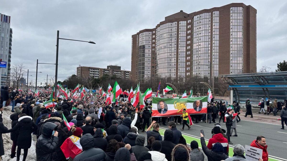 Rally participants hold a banner with images of Iranian Crown Prince Reza Pahlavi, whom they support as the opposition figure to oust the Islamic Republic, in Toronto on Jan. 10, 2026. (The Epoch Times)