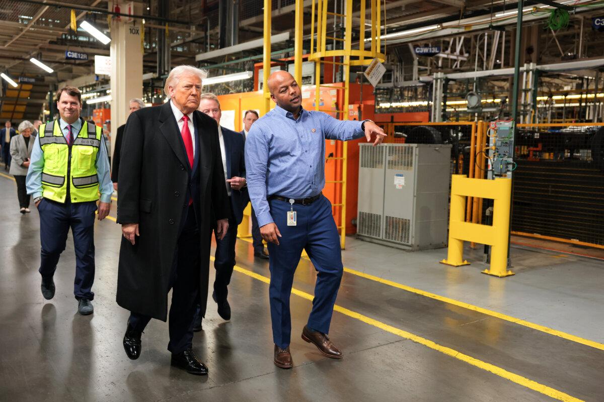 U.S. President Donald Trump walks with Ford River Rouge Plant Manager Corey Williams (R) as they tour the Ford River Rouge Complex in Dearborn, Mich., on Jan. 13, 2026. (Anna Moneymaker/Getty Images)