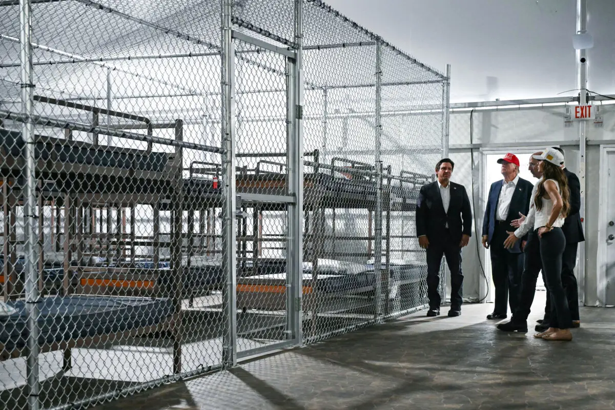 President Donald Trump (2nd L), Florida Gov. Ron DeSantis (L), and Secretary of Homeland Security Kristi Noem (R) tour a detention center for illegal immigrants, dubbed Alligator Alcatraz, located at the site of the Dade-Collier Training and Transition Airport in Ochopee, Fla., on July 1, 2025. (Andrew Caballero-Reynolds/AFP via Getty Images)