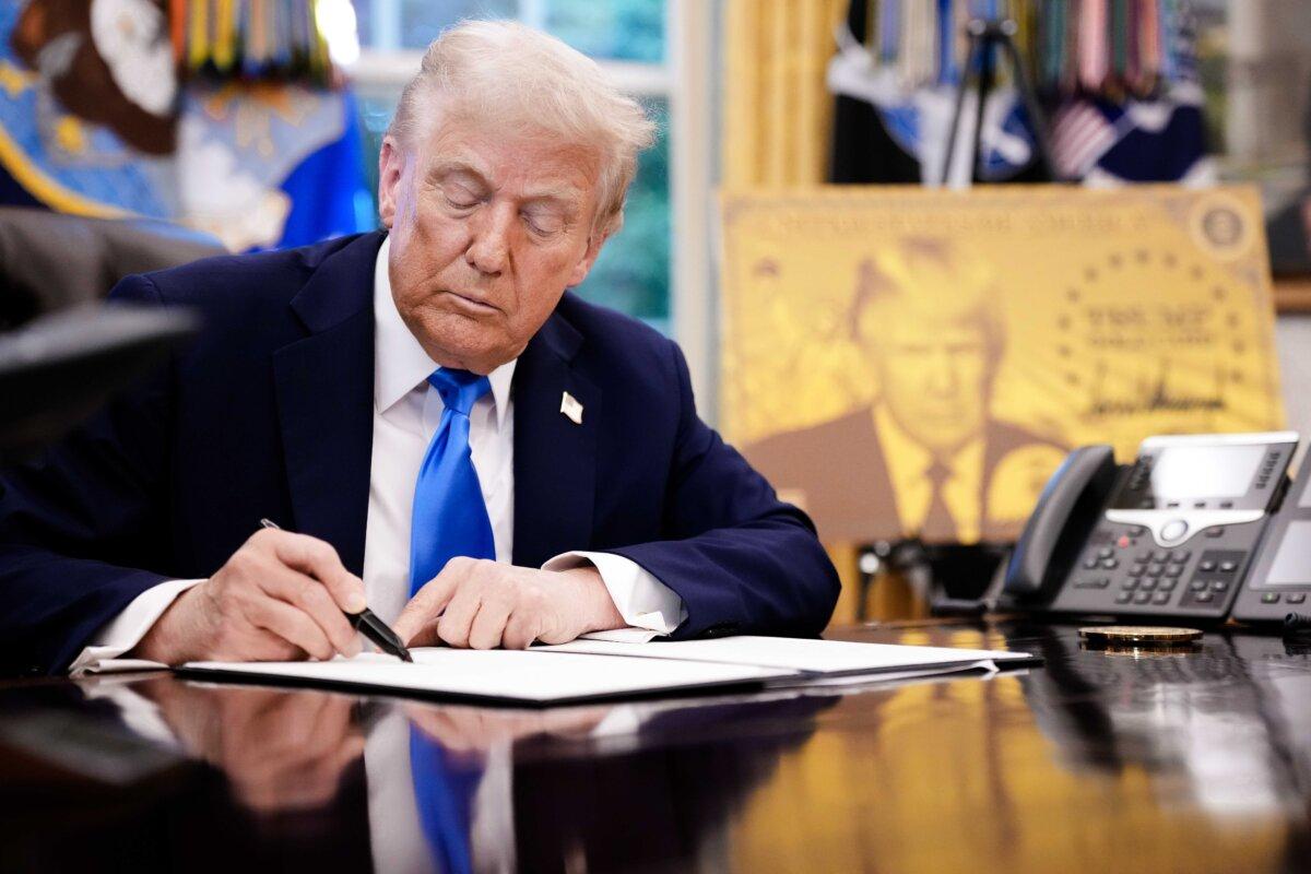 President Donald Trump signs an executive order in the Oval Office on Sept. 19, 2025. Trump signed a series of executive orders establishing the “Trump Gold Card” and introducing a $100,000 fee for H-1B visas. The "Trump Gold Card" is a visa program that allows foreign nationals permanent residency and a pathway to U.S. citizenship for a $1 million investment in the United States. (Andrew Harnik/Getty Images)