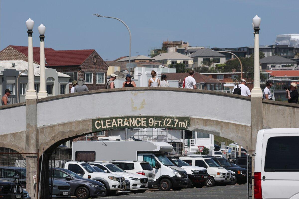 People walk across the footbridge that was used by the father-and-son gunmen during the Dec. 14 Bondi Beach shooting, in Sydney on Dec.18, 2025. (David Gray/AFP via Getty Images)