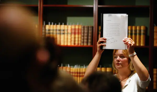 People attend an auction at Sotheby's auction house in London on July 8, 2004. (Graeme Robertson/Getty Images)