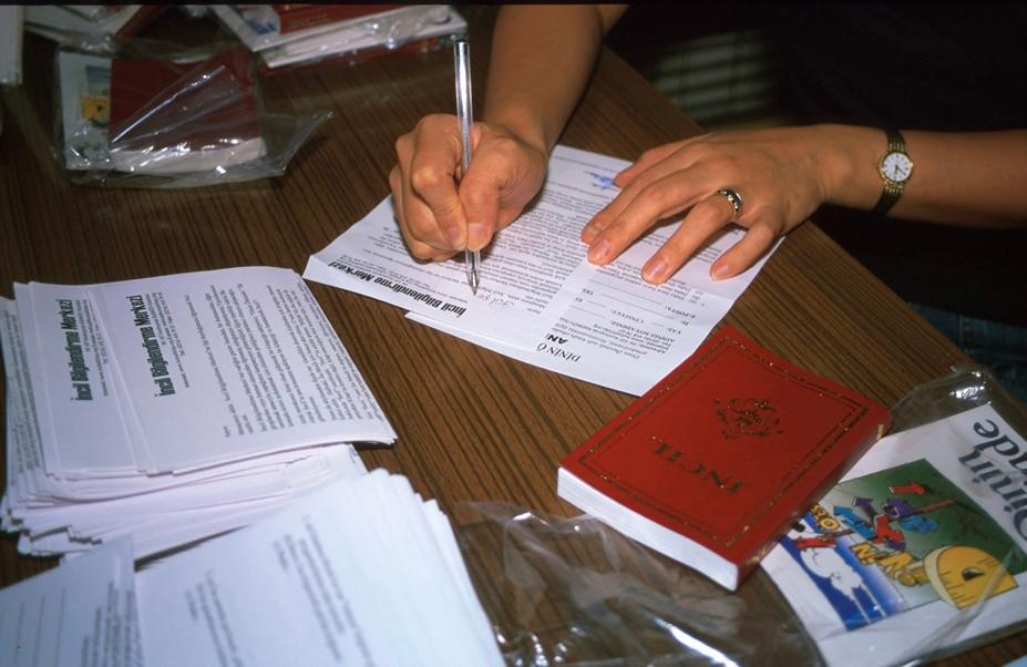Pam Wilson fills out a Bible correspondence course, with a Turkish New Testament. When the Wilsons developed their course in 1980, based on one begun by missionaries in the 1960s, it was one of the only publicly available ways to learn about Jesus or get a bible in Turkey, they said. (Courtesy of Pam Wilson)