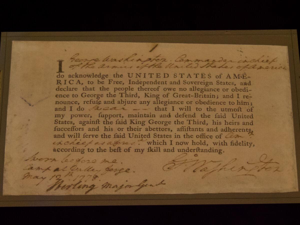 President George Washington's signed oath of allegiance from his service in the Continental Army is one of the documents traveling around the nation on the Freedom Plane, as seen in the National Archives in Washington on Jan. 20, 2026. (Travis Gillmore/The Epoch Times)