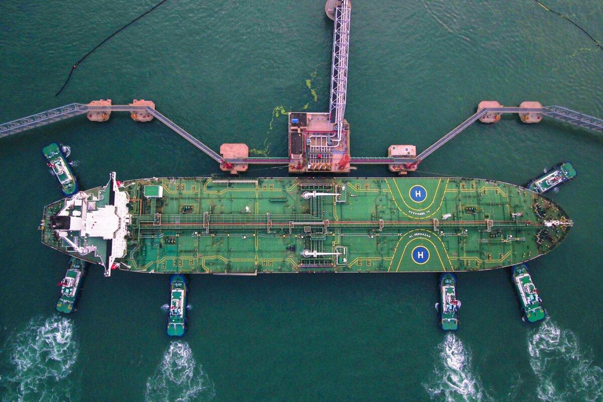 An aerial photo of tugboats berthing an oil tanker at Qingdao port in Qingdao, China, on Aug. 4, 2019. (STR/AFP via Getty Images)