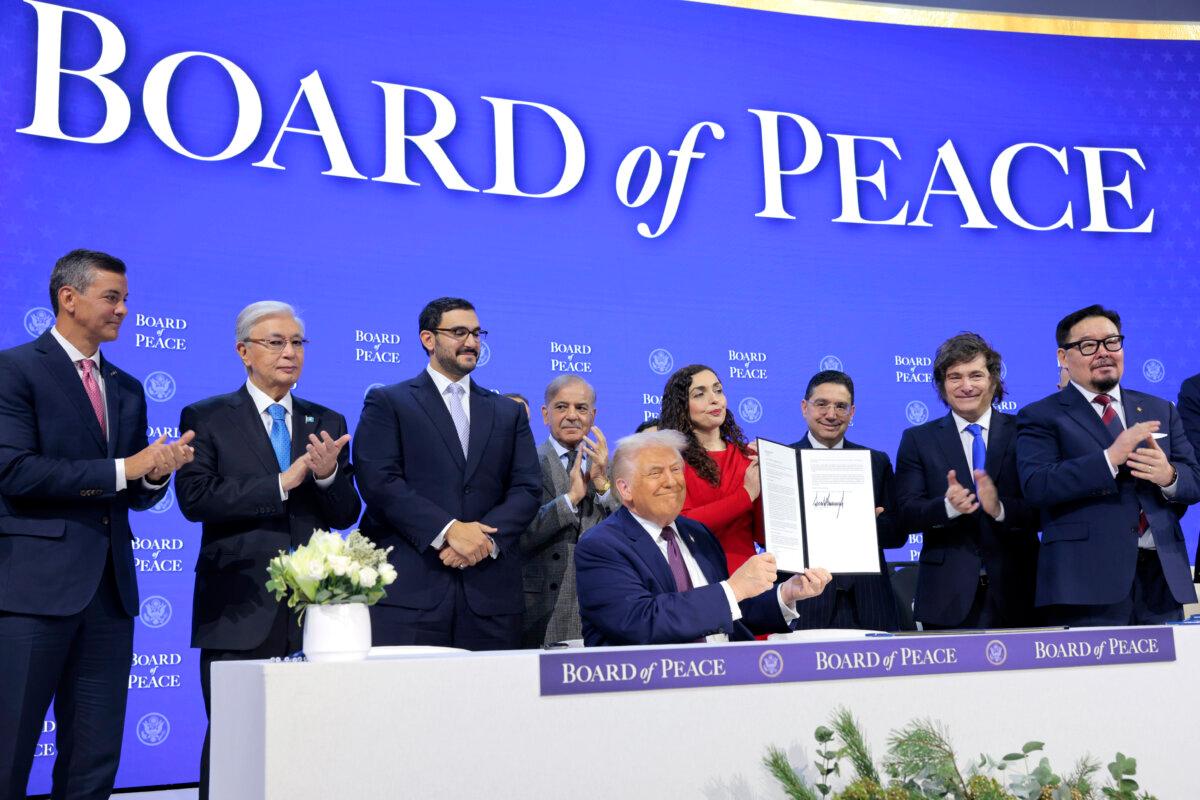 President Donald Trump holds up his signature during a signing ceremony for the “Board of Peace” at the World Economic Forum (WEF) in Davos, Switzerland, on Jan. 22, 2026. (Chip Somodevilla/Getty Images)