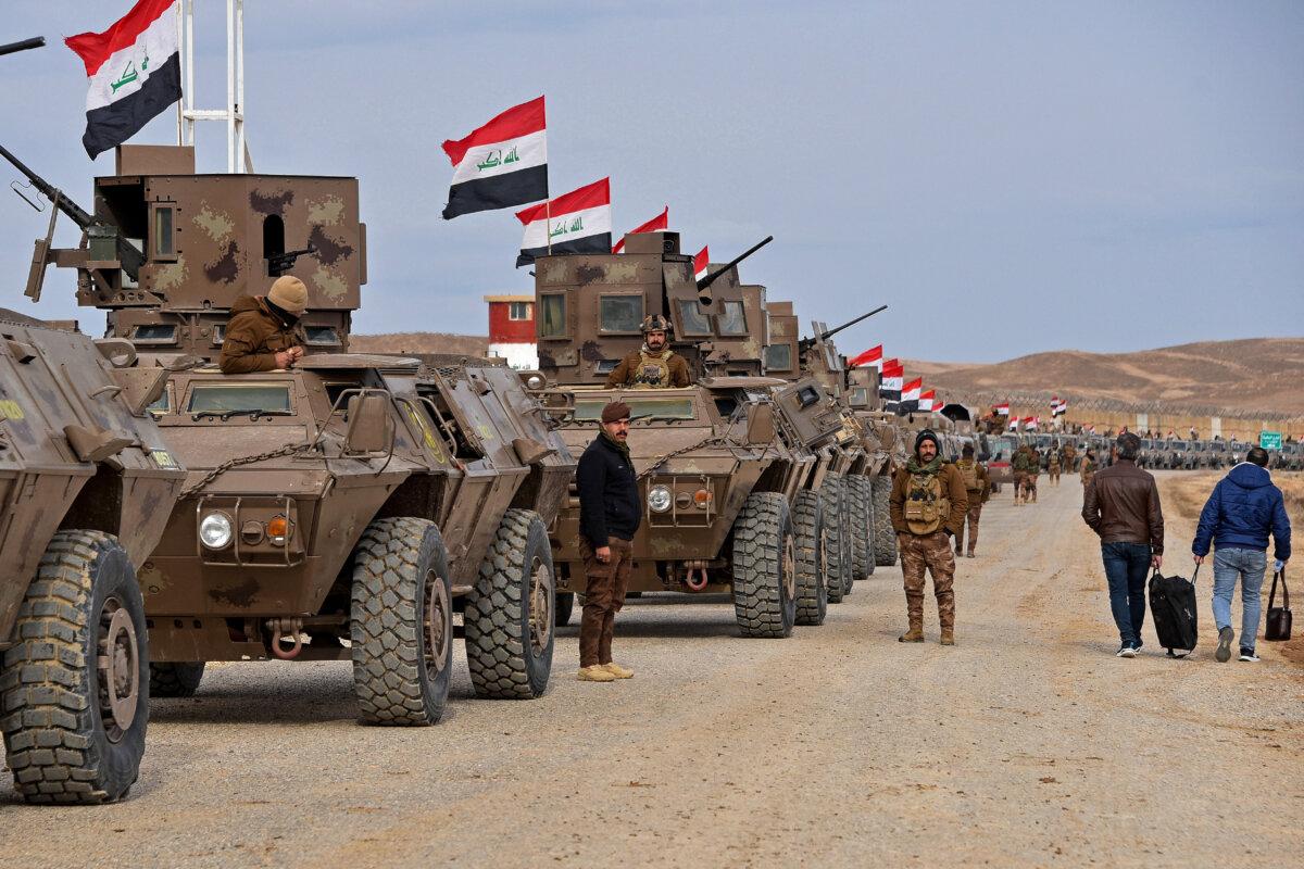 Iraqi border security force personnel stand guard next to their armored vehicles along the border with Syria, in Sinjar district, Iraq, on Jan. 22, 2026. (Zaid Al-Obeidi/AFP via Getty Images)