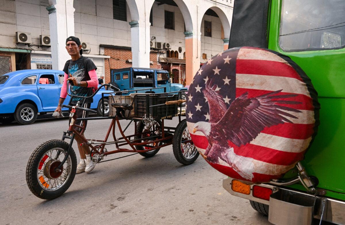 A man walks by a vehicle sporting a wheel cover featuring an image of the U.S. flag in Havana on Jan. 23, 2026. (Yamil Lage/AFP via Getty Images)