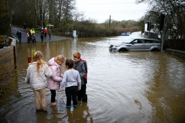 Day in Photos: Flood in England, Tsunami Museum, and Ice in the Hudson River