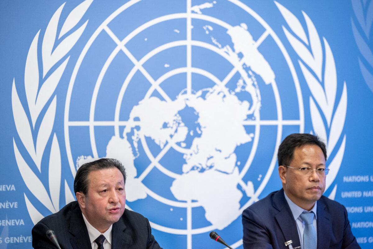 Yalqun Yaqup, deputy director-general of the Xinjiang region public security department (L), next to Xu Guixiang, director of the information office of China's Xinjiang region, delivers a speech during a press conference against a long-delayed U.N. report that warns of possible crimes against humanity in Xinjiang, on the sidelines of the 51st Human Rights Council, in Geneva on Sept. 22, 2022. (Fabrice Coffrini/ AFP via Getty Images)