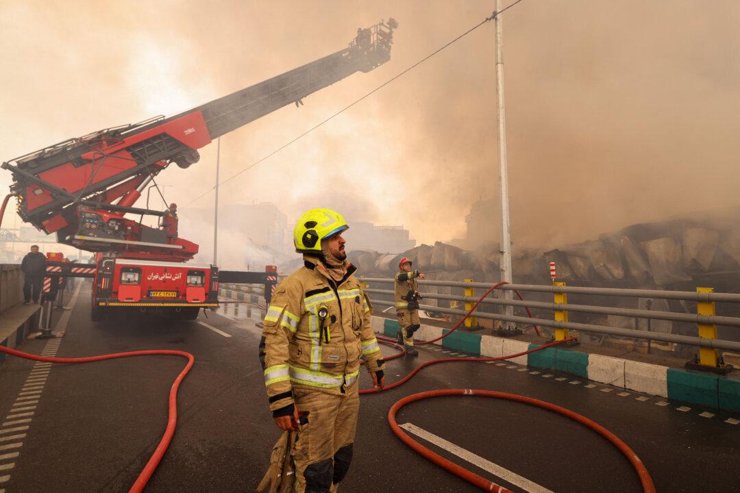 Firefighters battle a fire that broke out in Jannat Bazaar, west of Tehran on February 3, 2026. A massive fire broke out on February 3 at a bazaar west of the Iranian capital, state media reported, although the cause of the blaze was unclear. The fire erupted at a market in the Jannat Abad neighbourhood in Tehran's west, an area filled with stalls and shops, state TV quoted a spokesman for Tehran's fire department as saying. (Photo by ATTA KENARE / AFP via Getty Images)