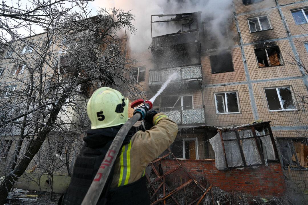 An Ukrainian firefighter works to extinguish a fire in a damaged residential building following an air attack in Kharkiv on February 3, 2026, amid the Russian invasion of Ukraine. (Photo by SERGEY BOBOK / AFP via Getty Images)