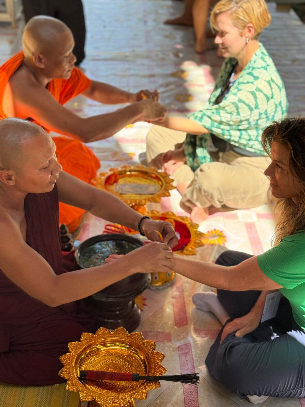 Buddhist monks in Cambodia gave our group a water blessing that culminated with tying string bracelets around our wrists. (Lori Rackl/TNS)