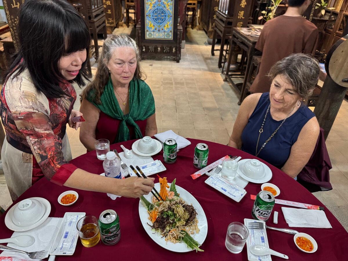 Dr. Phan Thuan Thao serves a Vietnamese vegetable and noodle dish her mother helped cook in their home in Hue. (Lori Rackl/TNS)