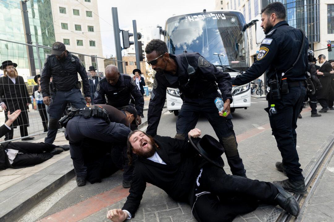 JERUSALEM, UNSPECIFIED - FEBRUARY 4: Israeli police officers disperse Ultra-Orthodox Jewish protesters as they are blocking a main road during a protest by ultra-Orthodox men in favor of their exemption from Israel's military draft on February 4, 2026 in Jerusalem. The government has been trying to pass a new law restoring the exemption of Ultra-orthodox (haredi) men from the country's conscription requirements, following a ruling by the High Court that found the longstanding exemption illegal. (Photo by Amir Levy/Getty Images)