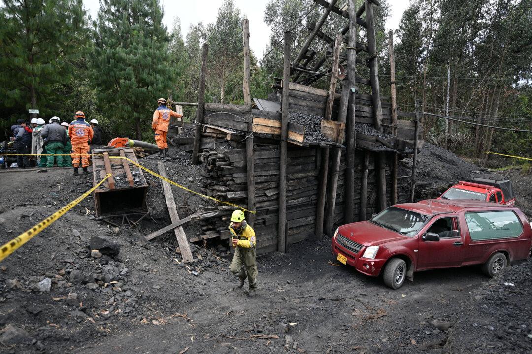 Members of a rescue team are seen outside the coal mine where six workers remain trapped after an explosion in Guacheta, Cundinamarca department, Colombia, on February 6, 2026. Rescuers are trying to find six workers trapped in an illegal coal mine in central Colombia after an explosion, although authorities suspect they may be dead. (Photo by Luis ACOSTA / AFP via Getty Images)