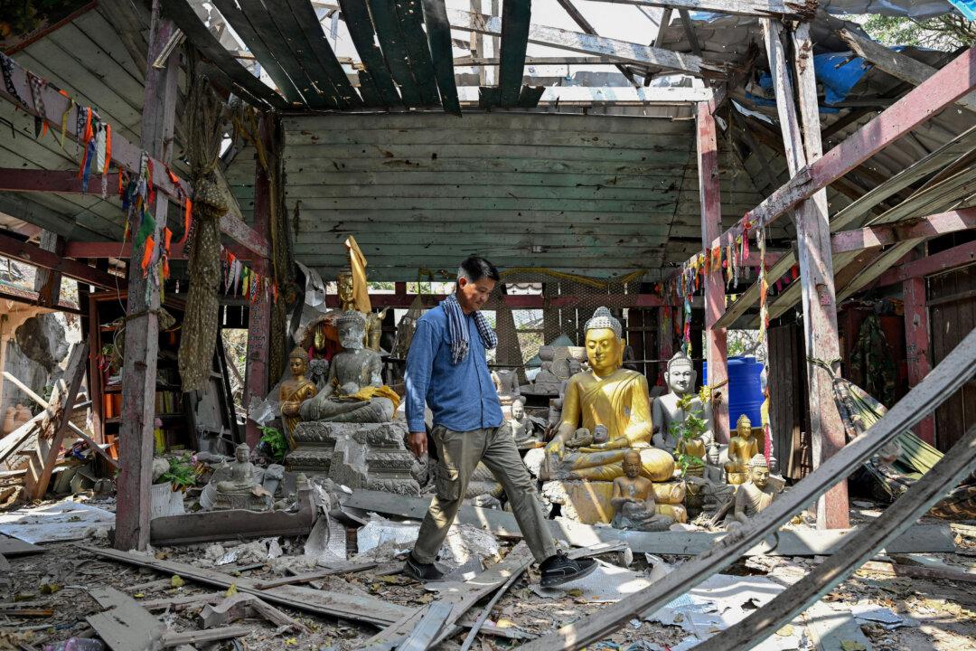 TOPSHOT - A man walks inside a damaged pagoda near the Preah Vihear temple in Preah Vihear province on February 6, 2026. Chunks of broken sandstone litter Cambodia's UNESCO-listed Preah Vihear temple, whose centuries-old sandstone facades are pocked with fresh shrapnel scars after weeks of deadly border clashes with neighbouring Thailand. Considered a masterpiece of Khmer architecture that looks out over the northern Cambodian plains, the temple became a war zone when a longstanding border dispute erupted into fighting with jets, artillery, tanks and ground troops last year. (Photo by TANG CHHIN Sothy / AFP via Getty Images) / To go with 'CAMBODIA-THAILAND-CONFLICT-HERITAGE, REPORTAGE' by Suy SE