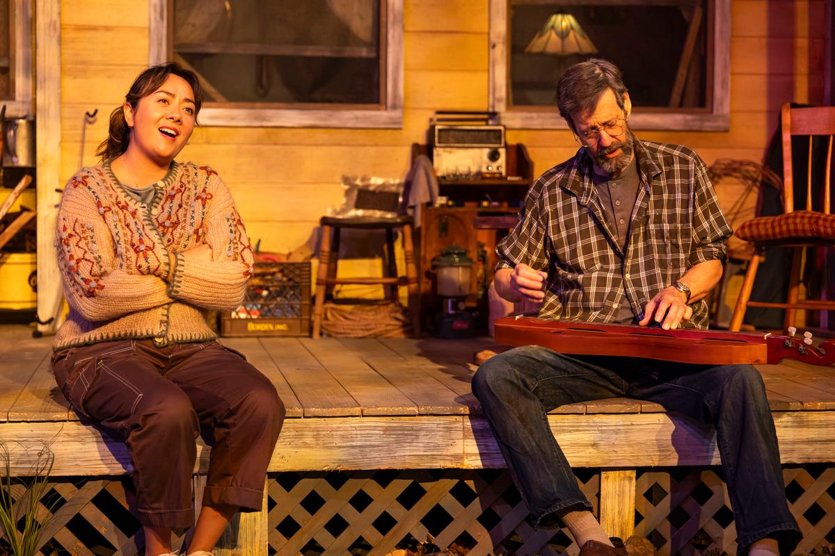 An olive branch is passed between Mira (Tora Nogami Alexander) and her grandfather Edgar (David M. Lutken), in "The Porch on Windy Hill." (Ben Hider)