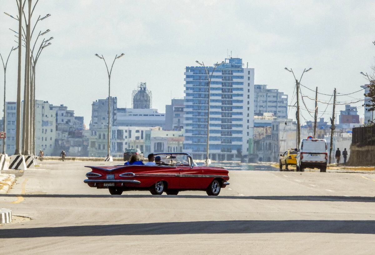 Tourists ride in an old American car used as a taxi along a quiet avenue in Havana on Feb. 8, 2026. (Adalberto Roque/ AFP via Getty Images)