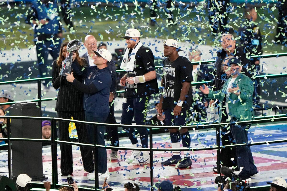 Head coach Mike MacDonald of the Seattle Seahawks hoists the Vince Lombardi Trophy after defeating the New England Patriots 29–13 to win Super Bowl LX at Levi's Stadium in Santa Clara, Calif., on Feb. 8, 2026. (Thearon W. Henderson/Getty Images)